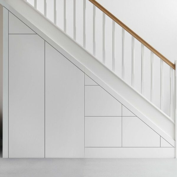 Custom under stairs storage with three drawers and a tall cupboard, designed for modern homes.
